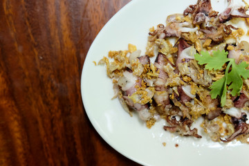 Squid Fried garlic and Seafood sauce in white dish