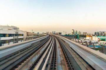 Fototapeta premium View from the cabin window on the rail road in the background of the urban area.