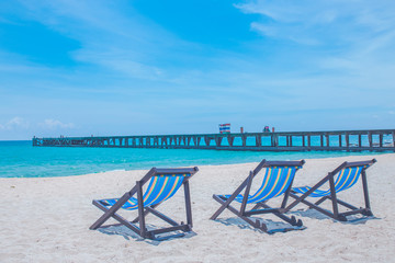Beach chairs and bridges with sea and bright sky