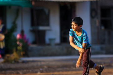 Rural Indian Child Playing Cricket