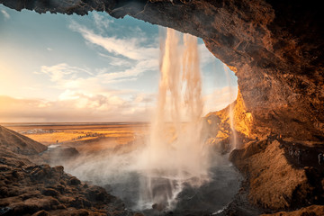 Beautiful sunset landscape of amazing Seljalandsfoss waterfall during the sunset, Beautiful waterfall in Iceland.