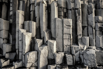 Column of basalt stone in The black sand beach of Reynisfjara and the mount Reynisfjall from the...