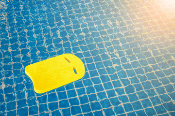 Yellow boogie foam board in swimming pool.