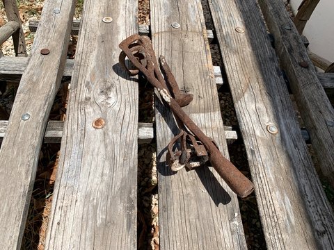 Fierros viejos y oxidados para marcar ganado sobre carretilla de madera