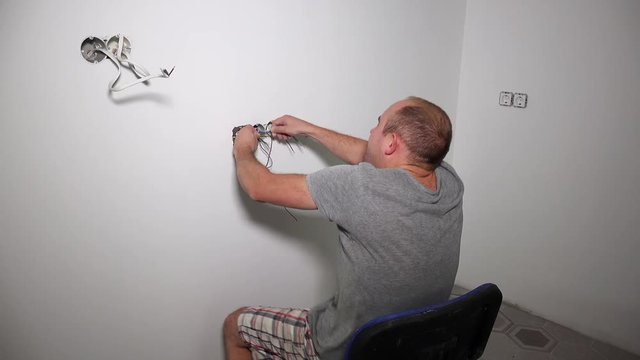 Crazy man get electric shock. Guy shake holding cable