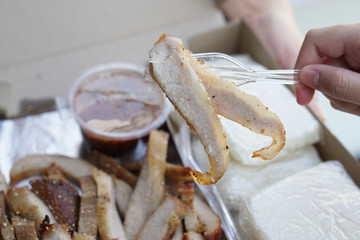 Grilled pork collar served with sticky rice, and Thai spicy dipping sauce (Jaew).