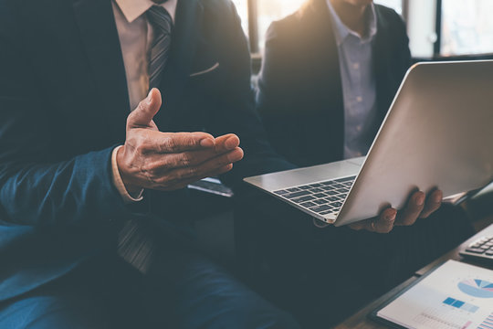 Business concept. Business people discussing the charts and graphs showing the results of their successful teamwork.