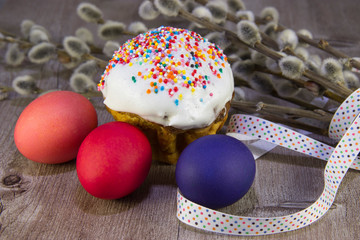 colorful Easter eggs with willow twig and Easter cake