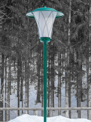 Green lantern in winter landscape