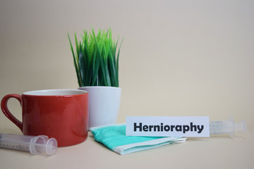 Hernioraphy text, grass pot, coffee cup, syringe, and face green mask. Healtcare/Medical and Business concept