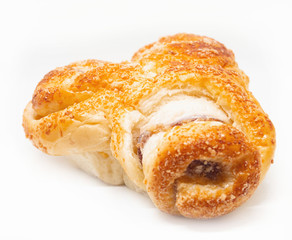 Buttered bread, sugar and stuffed with sausage on a white background