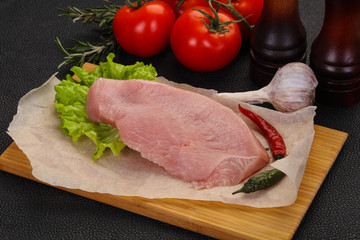 Raw Turkey steak served rosemary