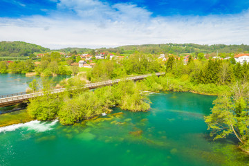 Obraz premium Croatia, green countryside, Mreznica river from air, panoramic view of Belavici village, waterfalls in spring, popular tourist destination