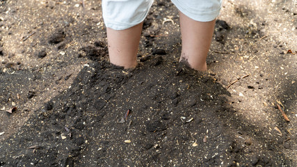 Bare foot on black sea sand ,Trat Thailand