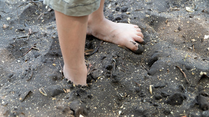 Bare foot on black sea sand ,Trat Thailand