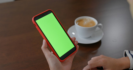 Woman use of mobile phone with green screen