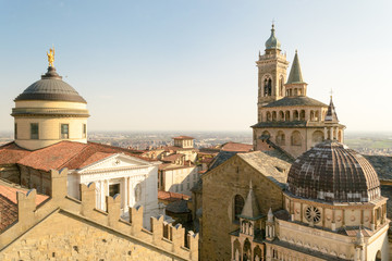 Fototapeta na wymiar Bergamo Upper City, Italy, march 2019. The two main churches of this city, the Duomo and Santa Maria Maggiore, seen from the 