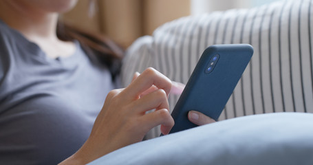 Close up of woman use of mobile phone at home