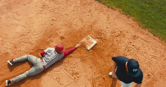 OVERHEAD CRANE Base runner attempts to touch a base during a baseball game. 4K UHD 60 FPS SLO MO RAW