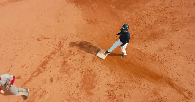 OVERHEAD CRANE Base runner attempts to touch a base during a baseball game. 4K UHD 60 FPS SLO MO RAW