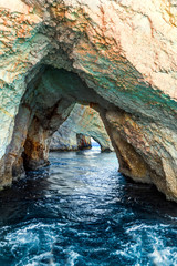  Bright blue sea water reflects coastal cliffs