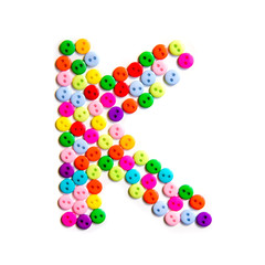 Letter K of the English alphabet made of multi-colored buttons