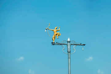Fototapeta na wymiar Phra Na Rai statue on Light pole with blue sky in background,signature of Lop Buri province,Thailand
