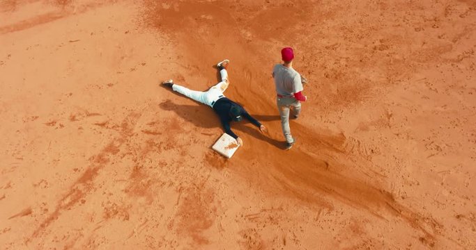 OVERHEAD CRANE Base runner attempts to touch a base during a baseball game. 4K UHD 60 FPS SLO MO RAW