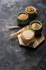 Fototapeta na wymiar Sattu sharbat is a cooling sweet drink made in summer with roasted black chickpea flour, barley, suger, salt & water. served in a glass. selective focus