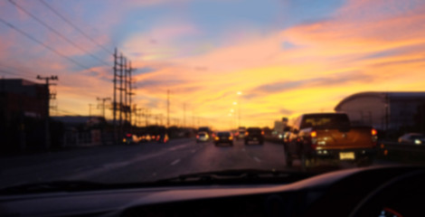 Fototapeta na wymiar Blurred background of view from driving a car on the road at sunrise.