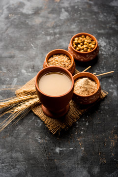 Sattu sharbat is a cooling sweet drink made in summer with roasted black chickpea flour, barley, suger, salt & water. served in a glass. selective focus