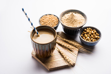 Sattu sharbat is a cooling sweet drink made in summer with roasted black chickpea flour, barley, suger, salt & water. served in a glass. selective focus
