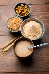 Sattu sharbat is a cooling sweet drink made in summer with roasted black chickpea flour, barley, suger, salt & water. served in a glass. selective focus