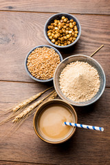 Sattu sharbat is a cooling sweet drink made in summer with roasted black chickpea flour, barley, suger, salt & water. served in a glass. selective focus
