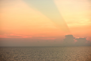 Colorful sky views after sunset at the sea With the light shining behind a beautiful cloud, used as...
