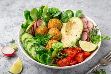 salad with avocado, falafel,cucumber, tomato and redish, healthy vegan lunch bowl