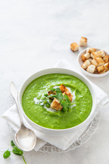 green peas cream soup in white bowl