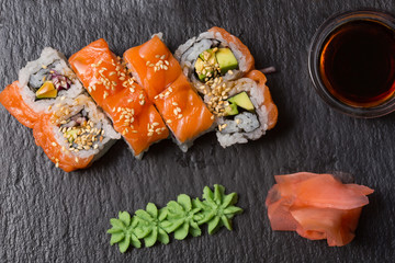 Smoked salmon sushi roll served on black stone