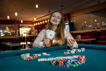Woman in casino showing combination of aces