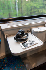 Smart phone and headset on train table