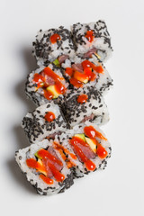 Smoked salmon sushi roll with organic black sesame