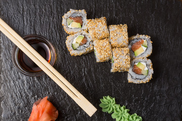 Smoked salmon roll sushi served on blackstone