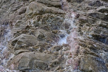 Close up big sea rock with white sand for background backdrop 