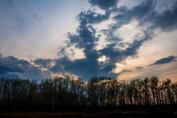 heavy lead clouds gathered over the Ural river before sunset