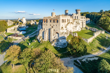 The ruins of medieval castle on the rock in Ogrodzieniec, Poland. One of strongholds  called Eagles Nests in Polish Jurassic Highland in Silesia. Aerial view - obrazy, fototapety, plakaty