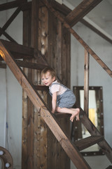 boy climbs the wooden stairs in casual interior