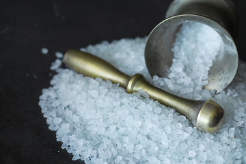 Large sea salt. Spice. Mortar and pestle for grinding.