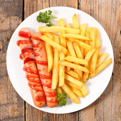 french fries and sausage with ketchup