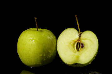 Apples fruits with drops and splashes of water on a black background