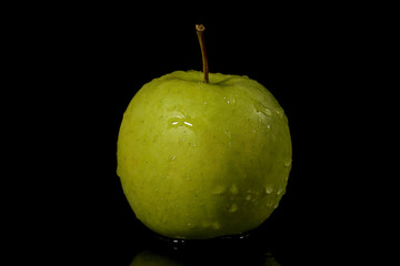 Apples fruits with drops and splashes of water on a black background